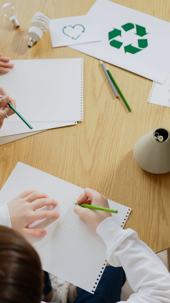 hero-img-01 Kids drawing eco-friendly symbols, promoting recycling and sustainability.